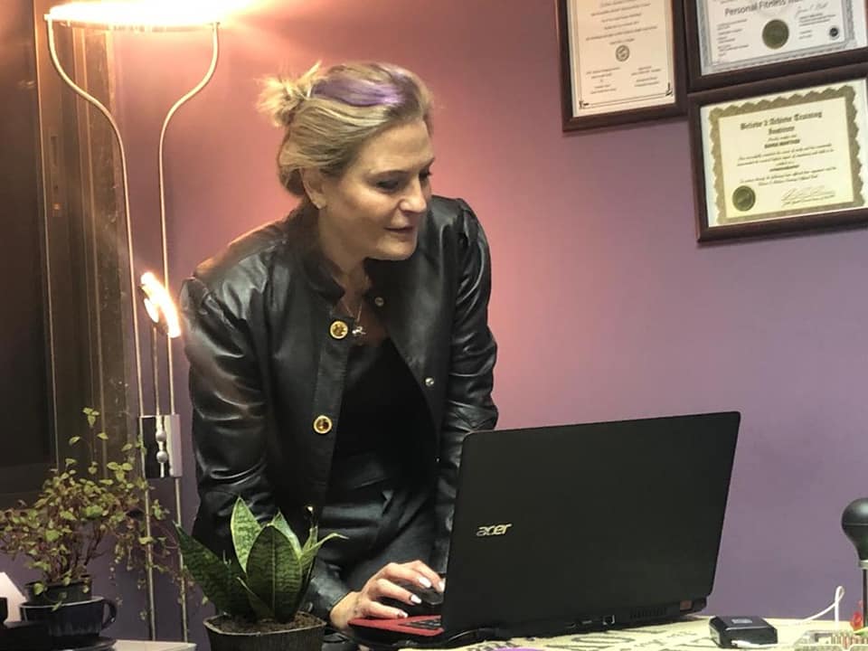 Coach Bee at her laptop
